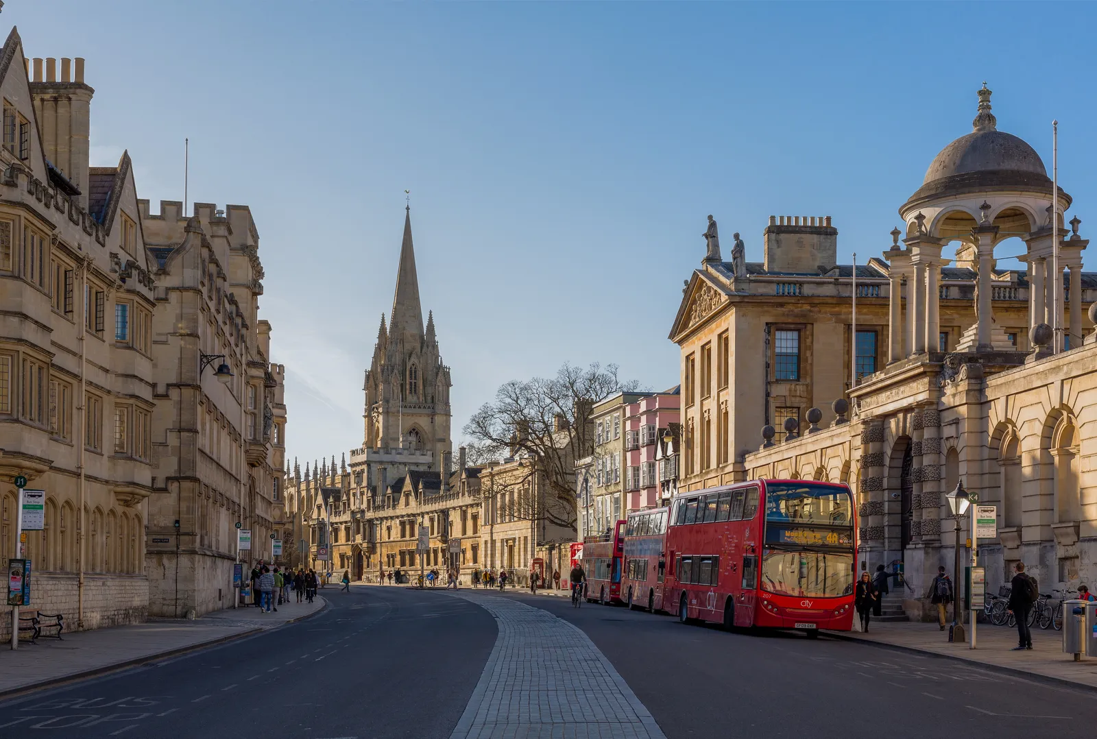 Oxford High Street looking west, with the spire of the University Church of St Mary the Virgin and college buildings lining the street
